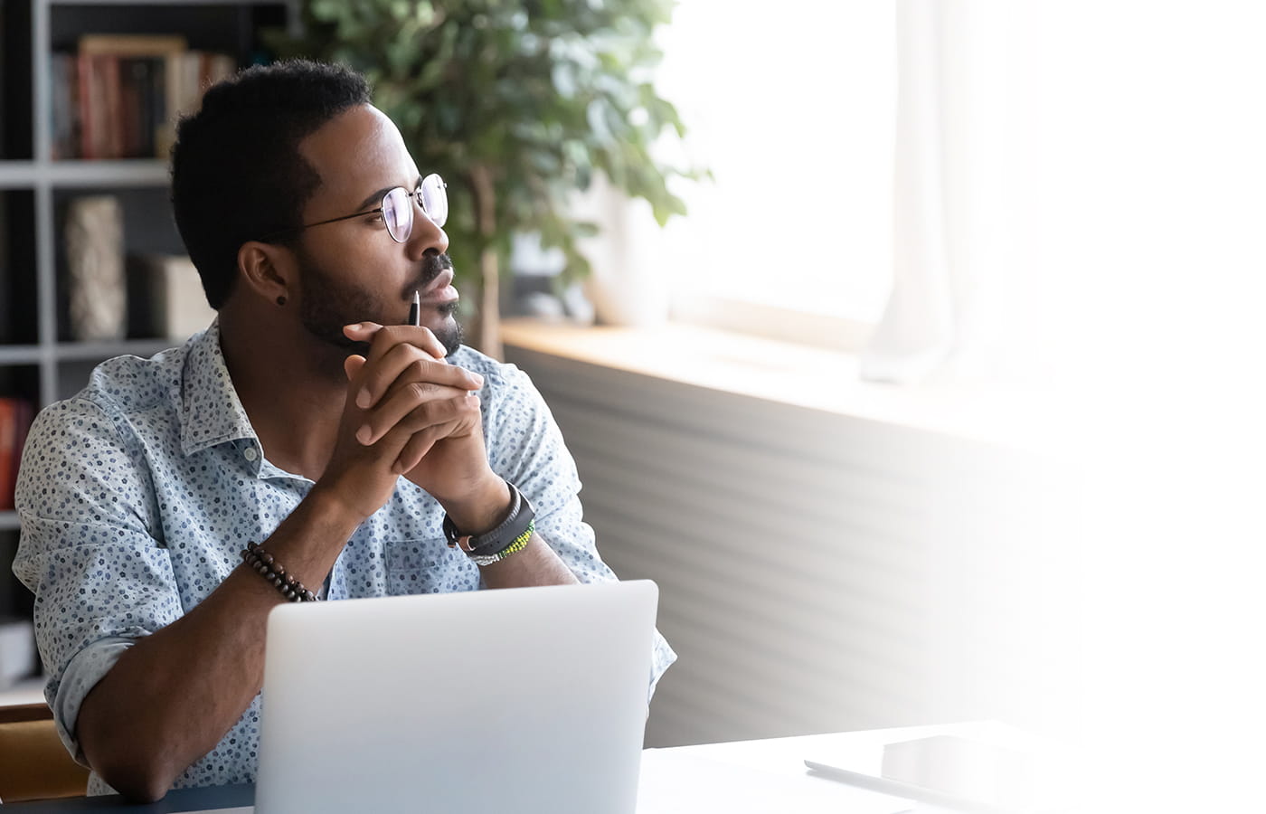 Man looking out window
